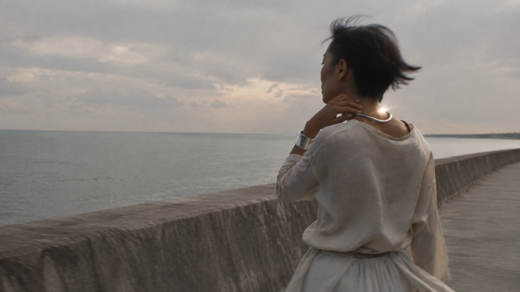A person by the sea wearing silver